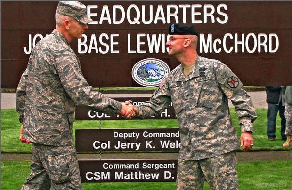 Joint Base Lewis-McChord Deputy Commander Air Force Col. Jerry K. Weldon II , left, and Commander Army Col. Thomas H. Brittain shake hands after the unveiling of the JBLM sign during a ceremony at the Joint Base Garrison building Monday morning, Feb.1, 2010. Fort Lewis and McChord AFB officially combined in 2010 as a way to streamline operations and save taxpayer money.